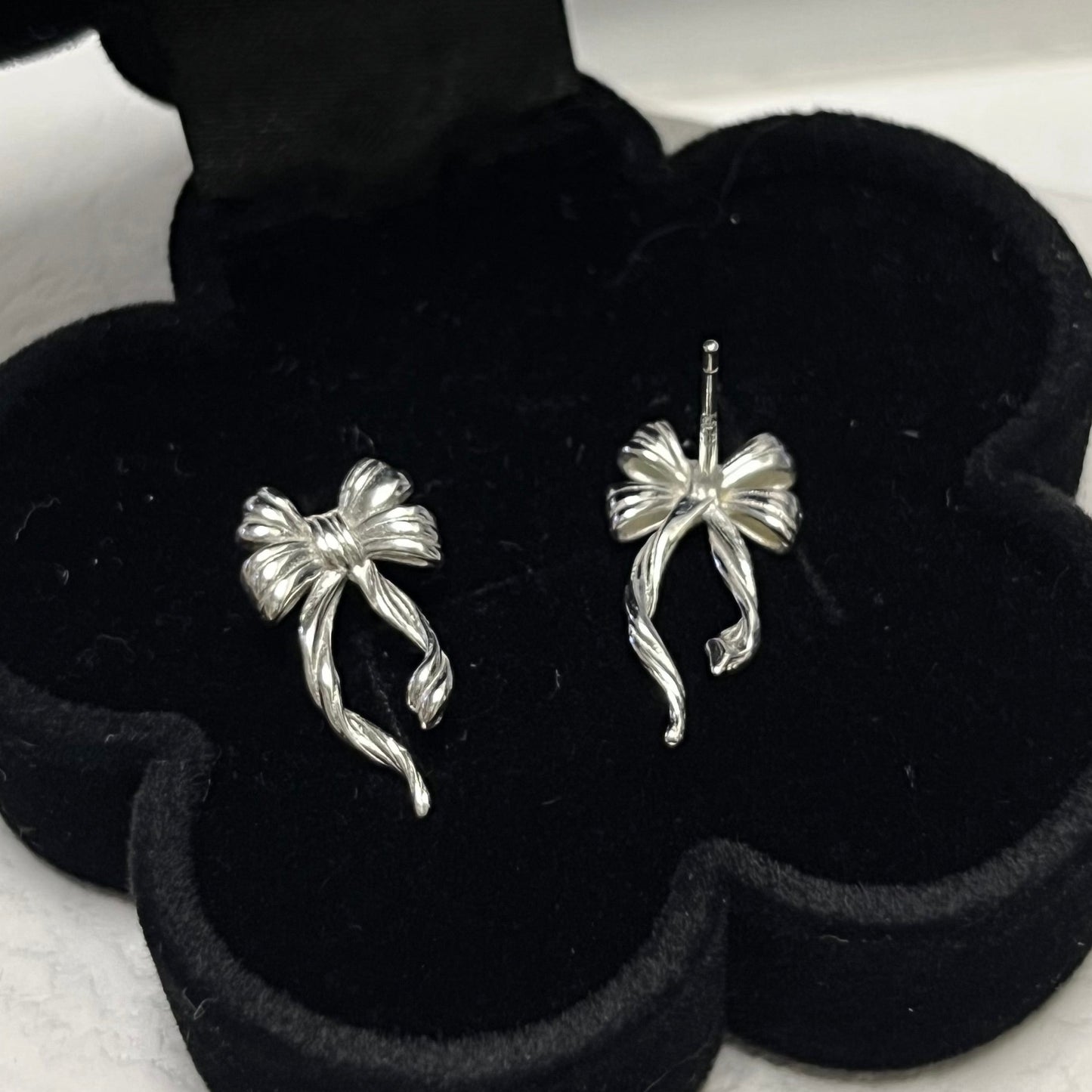 Discover the elegant E42 The Bow Earrings, crafted from premium 925 silver for a timeless shine. This Korea-inspired accessory features delicate bow motifs, perfect for everyday glamour or special occasions. Hypoallergenic, lightweight, and versatile—elevate your style with subtle sophistication. Ideal for fashion enthusiasts seeking affordable luxury.

#SilverEarrings, #925SterlingSilver, #SterlingSilverEarrings, #SilverJewelry, #HandmadeEarrings, #StatementEarrings, #EarringStyle, #MinimalistEarrings, 