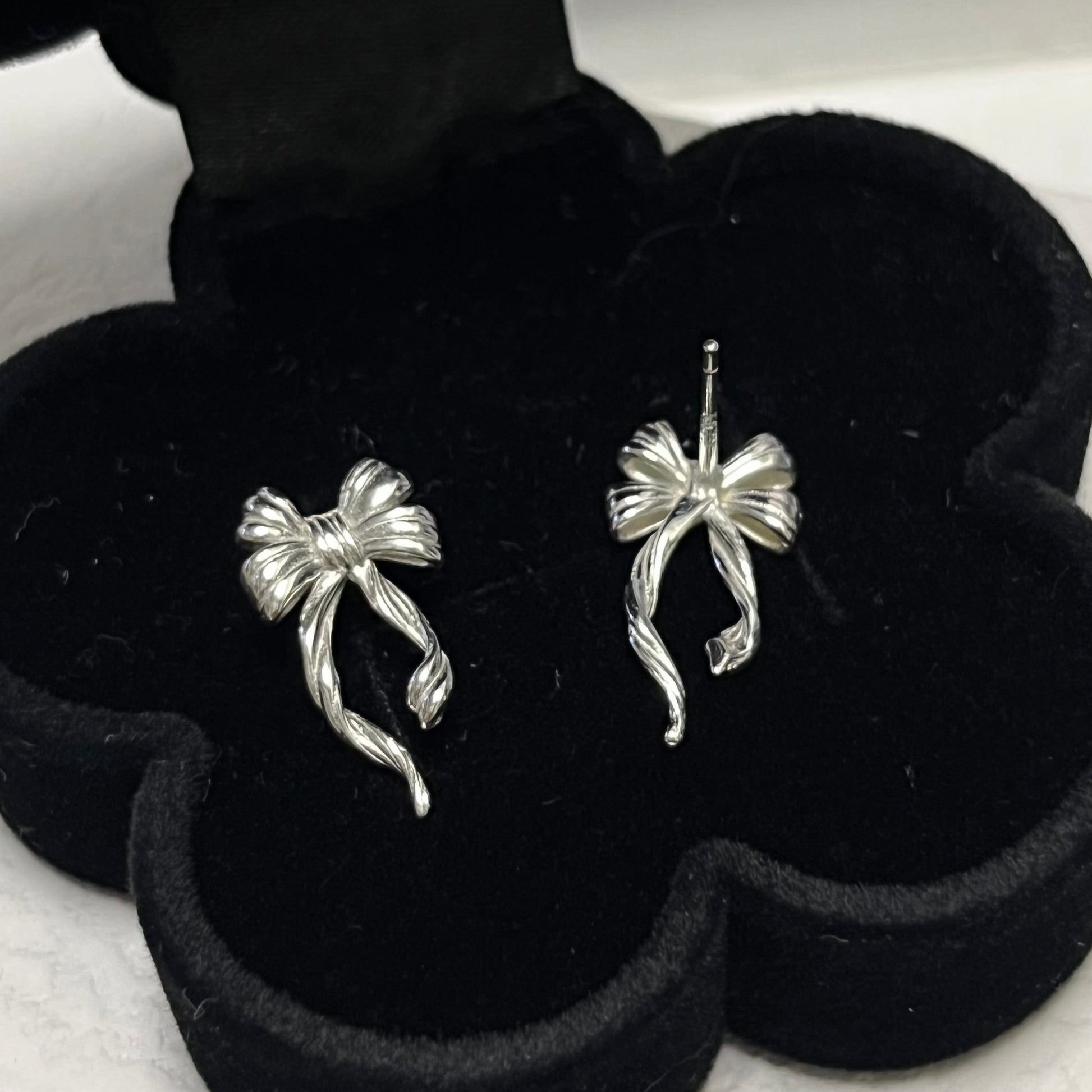 Discover the elegant E42 The Bow Earrings, crafted from premium 925 silver for a timeless shine. This Korea-inspired accessory features delicate bow motifs, perfect for everyday glamour or special occasions. Hypoallergenic, lightweight, and versatile—elevate your style with subtle sophistication. Ideal for fashion enthusiasts seeking affordable luxury.

#SilverEarrings, #925SterlingSilver, #SterlingSilverEarrings, #SilverJewelry, #HandmadeEarrings, #StatementEarrings, #EarringStyle, #MinimalistEarrings, 