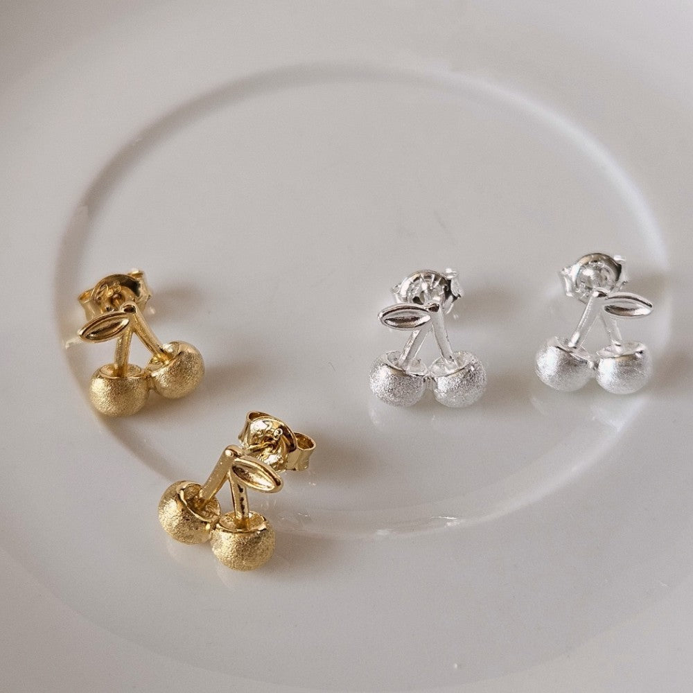 Indulge in playful charm with E43 Cherry Earrings, exquisitely crafted in 925 silver. This Korea-inspired accessory features dainty cherry drops, blending cute and chic for daily wear or gifting. Hypoallergenic, lightweight, and radiant—add a fruity pop of elegance to any look with timeless sophistication.

#SilverEarrings, #925SterlingSilver, #SterlingSilverEarrings, #SilverJewelry, #HandmadeEarrings, #StatementEarrings, #EarringStyle, #MinimalistEarrings, #FashionJewelry, #JewelryAddict